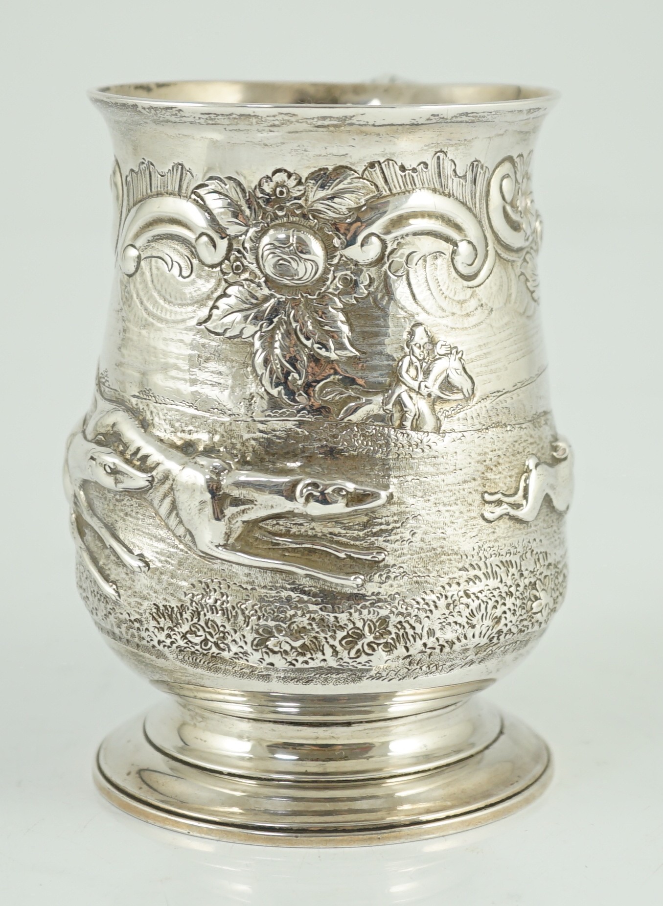 A George III silver baluster mug, later embossed with continuous hare coursing scene, John Scofield